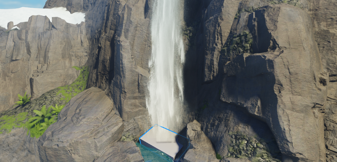A close up view of the bottom of the cliff with a block part positioned at the point where the cascades impact the plunge pool.